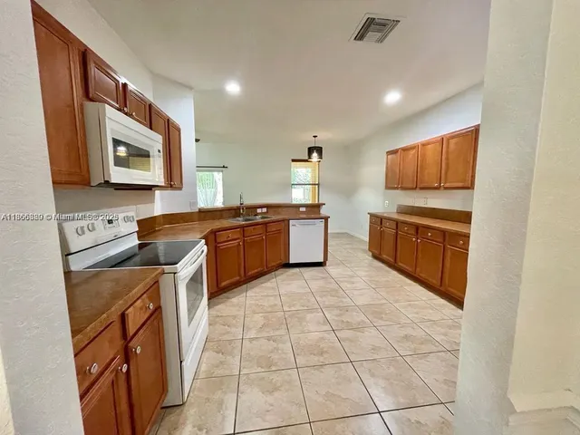 a kitchen with stainless steel appliances granite countertop a sink and cabinets