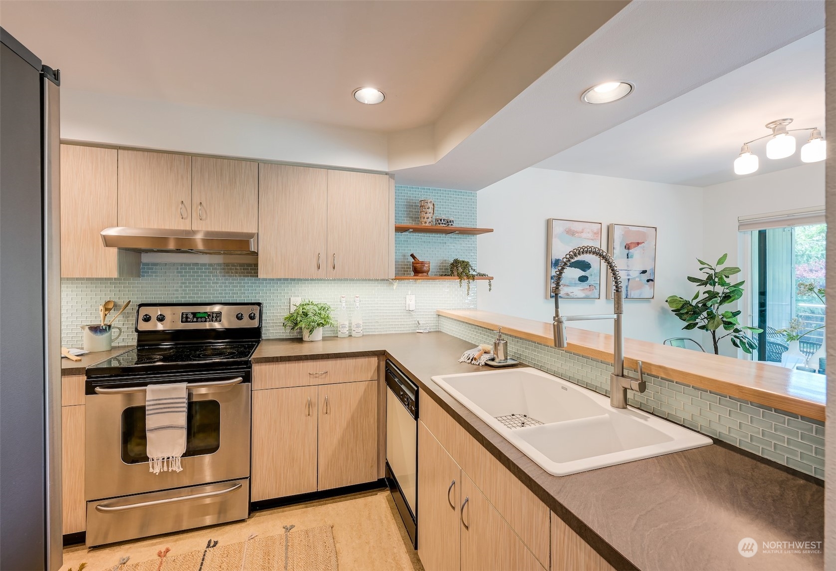 3912 Midvale Avenue North, Unit 201 Seattle, WA 98103 - Photo 11 of 22 a kitchen with a sink stove and cabinets