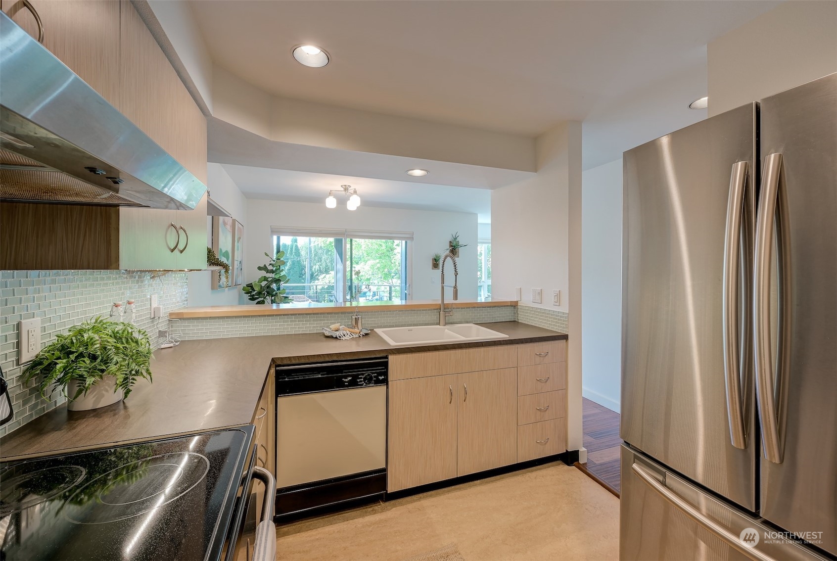 3912 Midvale Avenue North, Unit 201 Seattle, WA 98103 - Photo 12 of 22 a kitchen with stainless steel appliances granite countertop a refrigerator a sink and a stove