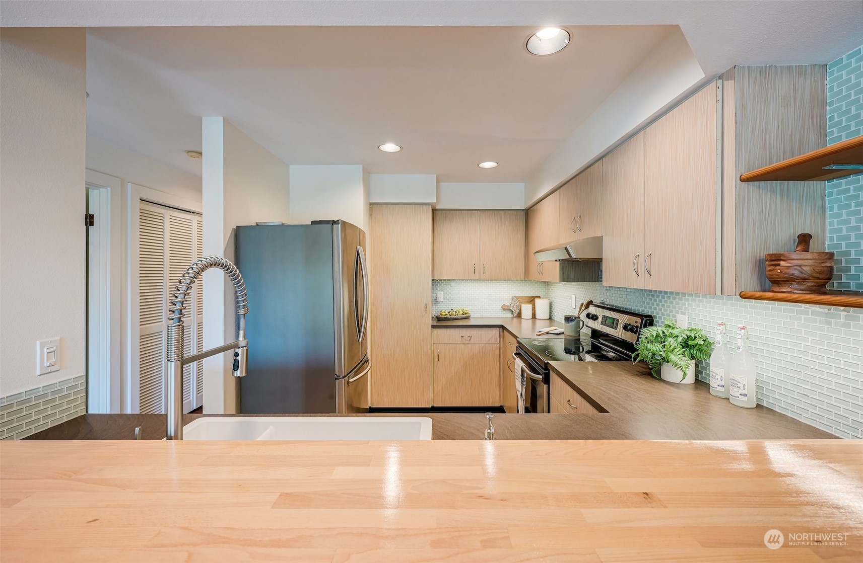 3912 Midvale Avenue North, Unit 201 Seattle, WA 98103 - Photo 13 of 22 a kitchen with stainless steel appliances granite countertop a refrigerator a stove and a sink