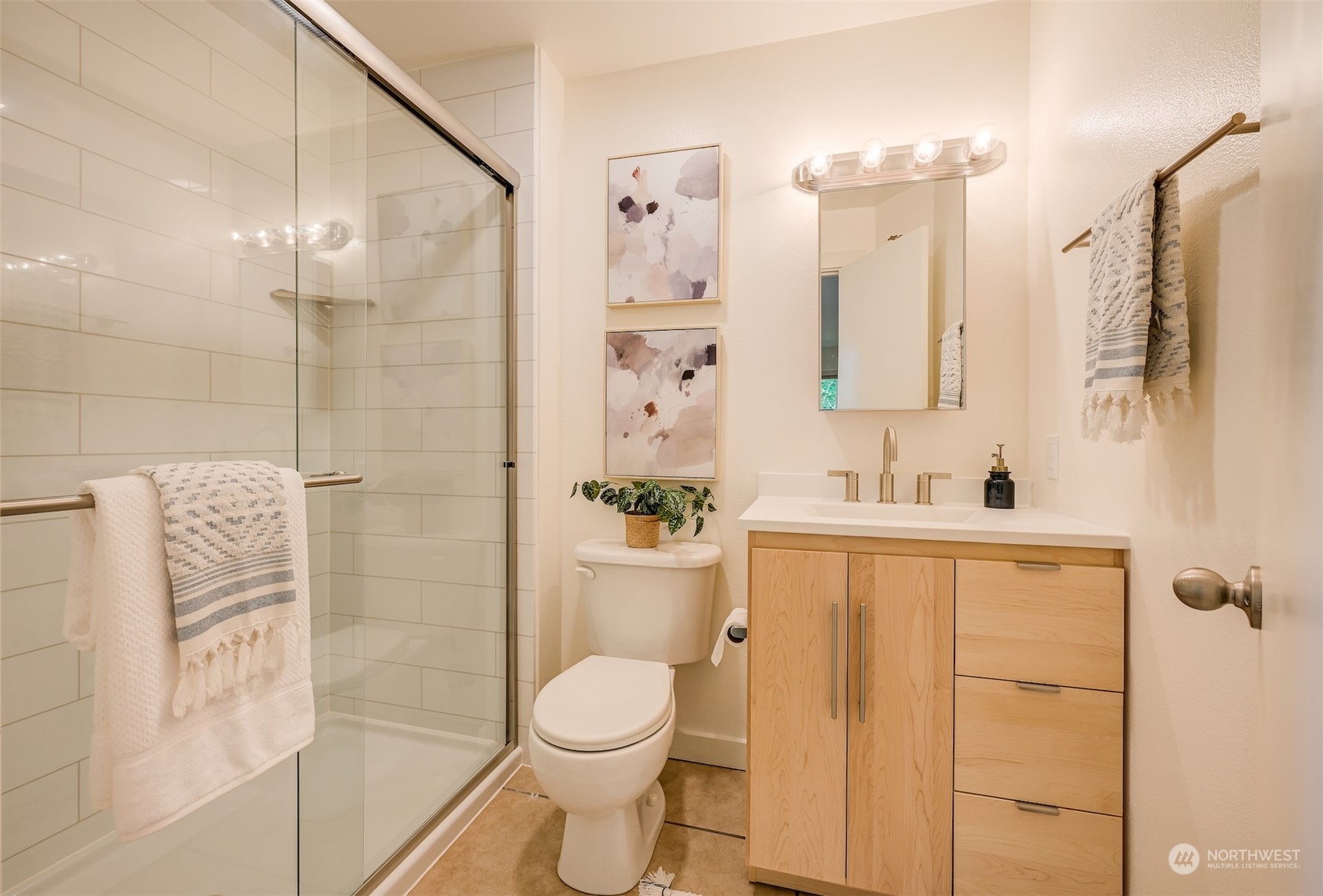3912 Midvale Avenue North, Unit 201 Seattle, WA 98103 - Photo 17 of 22 a bathroom with a sink mirror toilet and shower