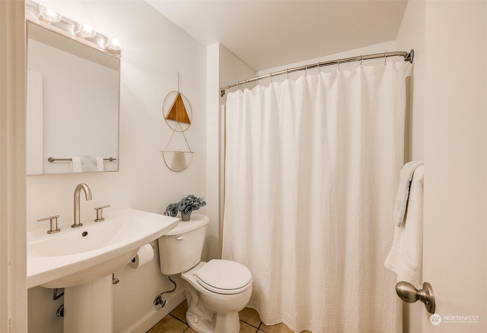 3912 Midvale Avenue North, Unit 201 Seattle, WA 98103 - Photo 20 of 22 a bathroom with a sink a toilet and shower curtain