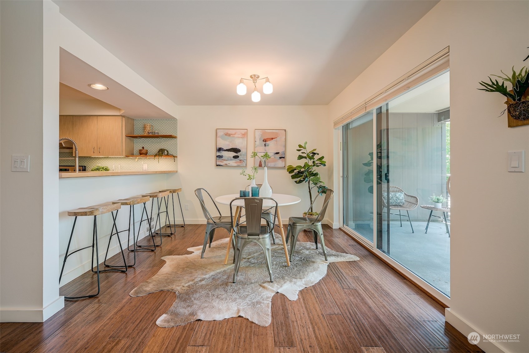 3912 Midvale Avenue North, Unit 201 Seattle, WA 98103 - Photo 5 of 22 a view of a dining room and livingroom with furniture wooden floor a chandelier