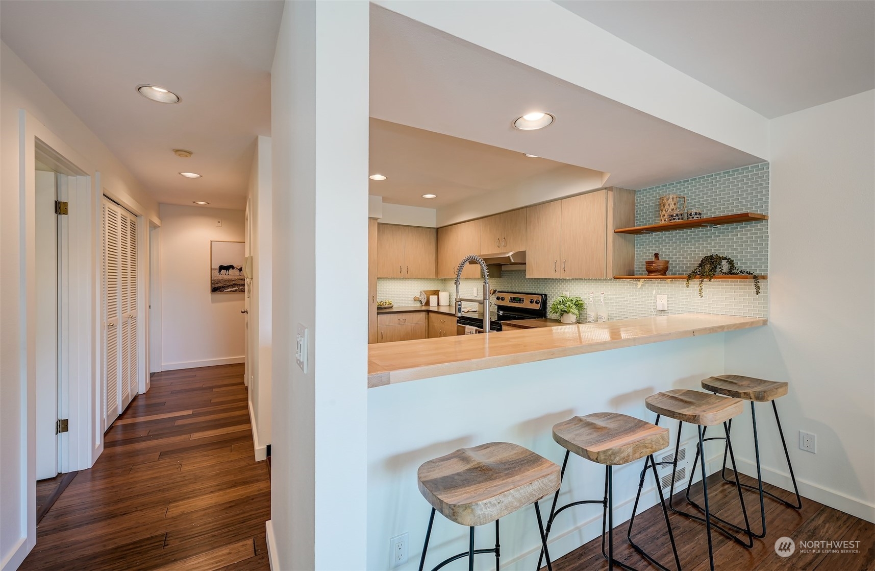 3912 Midvale Avenue North, Unit 201 Seattle, WA 98103 - Photo 9 of 22 a view of a kitchen with kitchen island white cabinets and stainless steel appliances