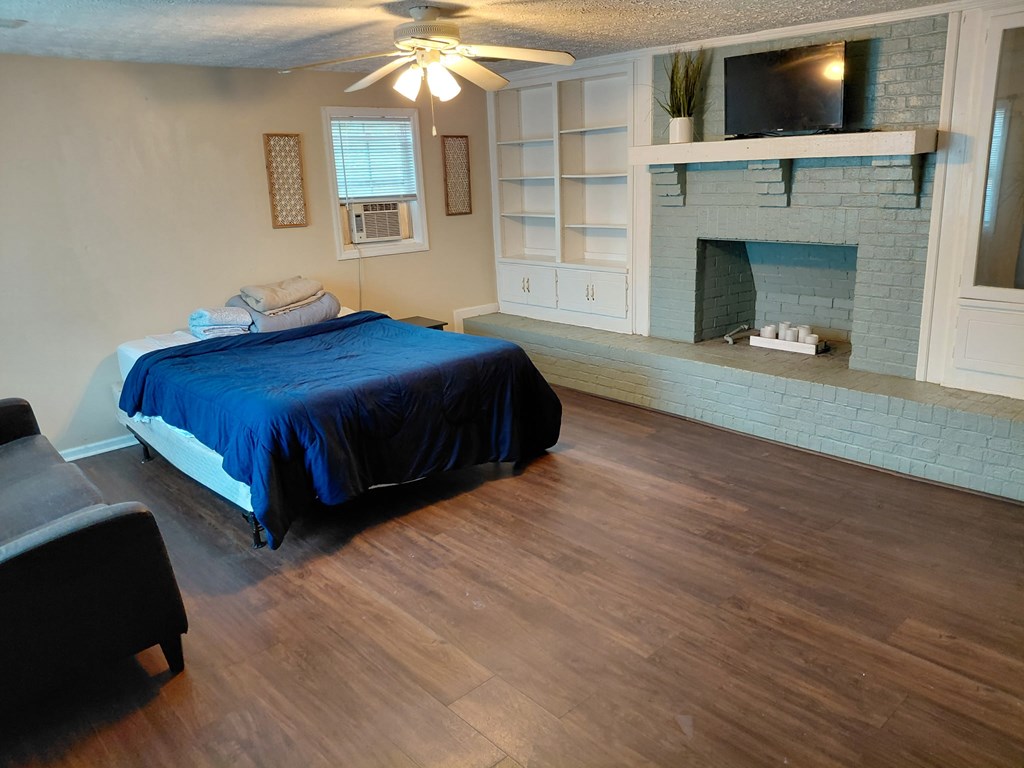 3641 Reese Road Columbus, GA 31907 - Photo 5 of 9 a spacious bedroom with a bed and a fireplace