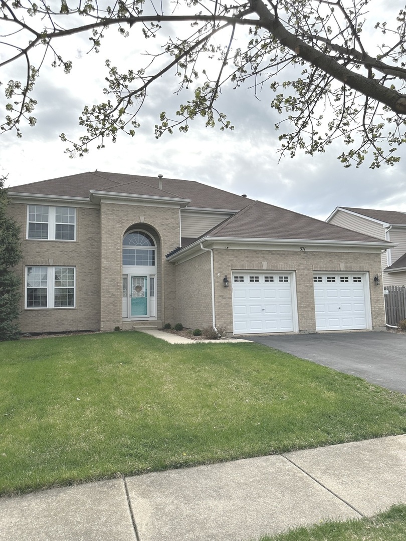 a front view of a house with a yard and garage