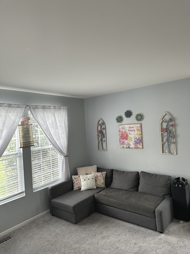 571 Wynbrooke Road Romeoville, IL 60446 - Photo 2 of 15 a living room with furniture and a window