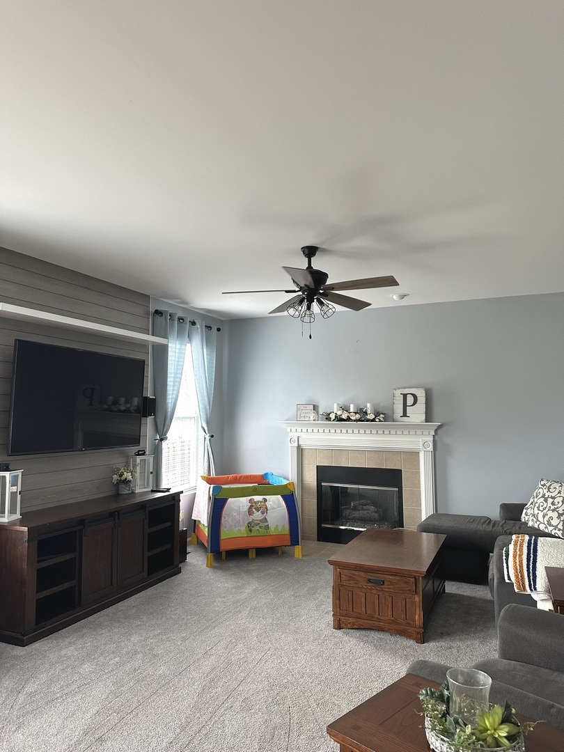 571 Wynbrooke Road Romeoville, IL 60446 - Photo 4 of 15 a living room with furniture and a fireplace