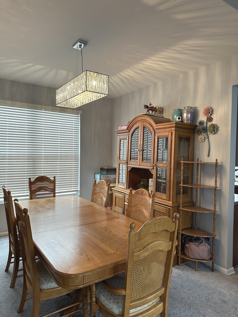 571 Wynbrooke Road Romeoville, IL 60446 - Photo 5 of 15 a view of a dining room with furniture and a chandelier