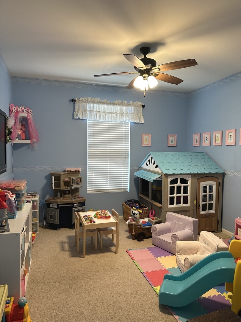 571 Wynbrooke Road Romeoville, IL 60446 - Photo 6 of 15 a living room with furniture a flat screen tv and a window