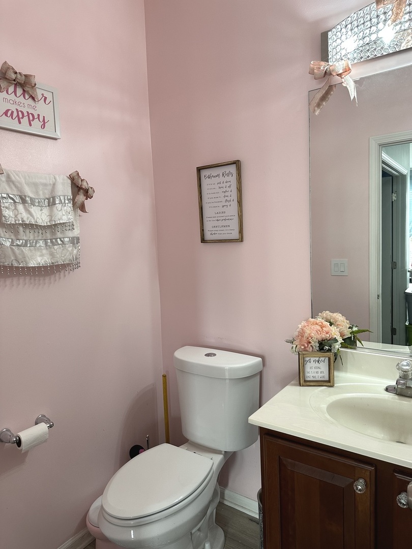 571 Wynbrooke Road Romeoville, IL 60446 - Photo 7 of 15 a bathroom with a toilet a sink and mirror