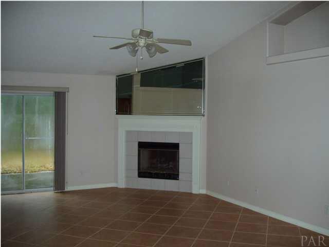 This is a huge Great Room and is accented with plant ledges, bull nose corners, tile floors and this cozy fireplace.