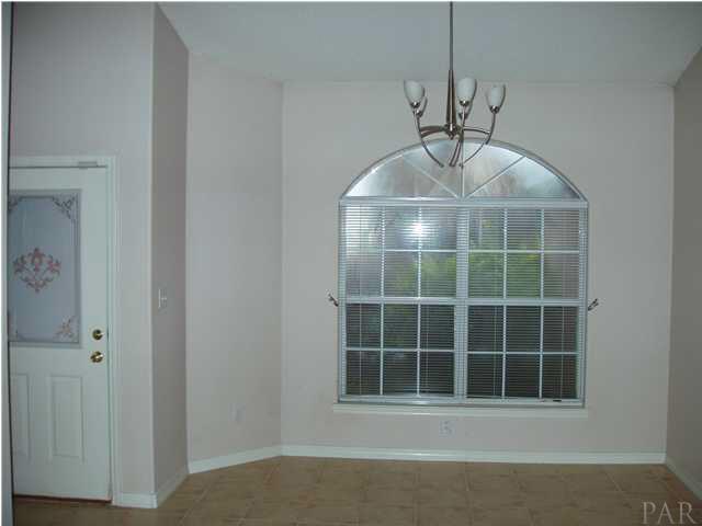 The Formal Dining Room is highlighted by this large moon shaped window bringing in lots of light.