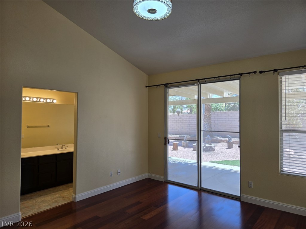 8417 San Ramon Drive Las Vegas, NV 89147 - Photo 27 of 33 Rich hardwood flooring complements backyard views through a spacious sliding door in this versatile room.