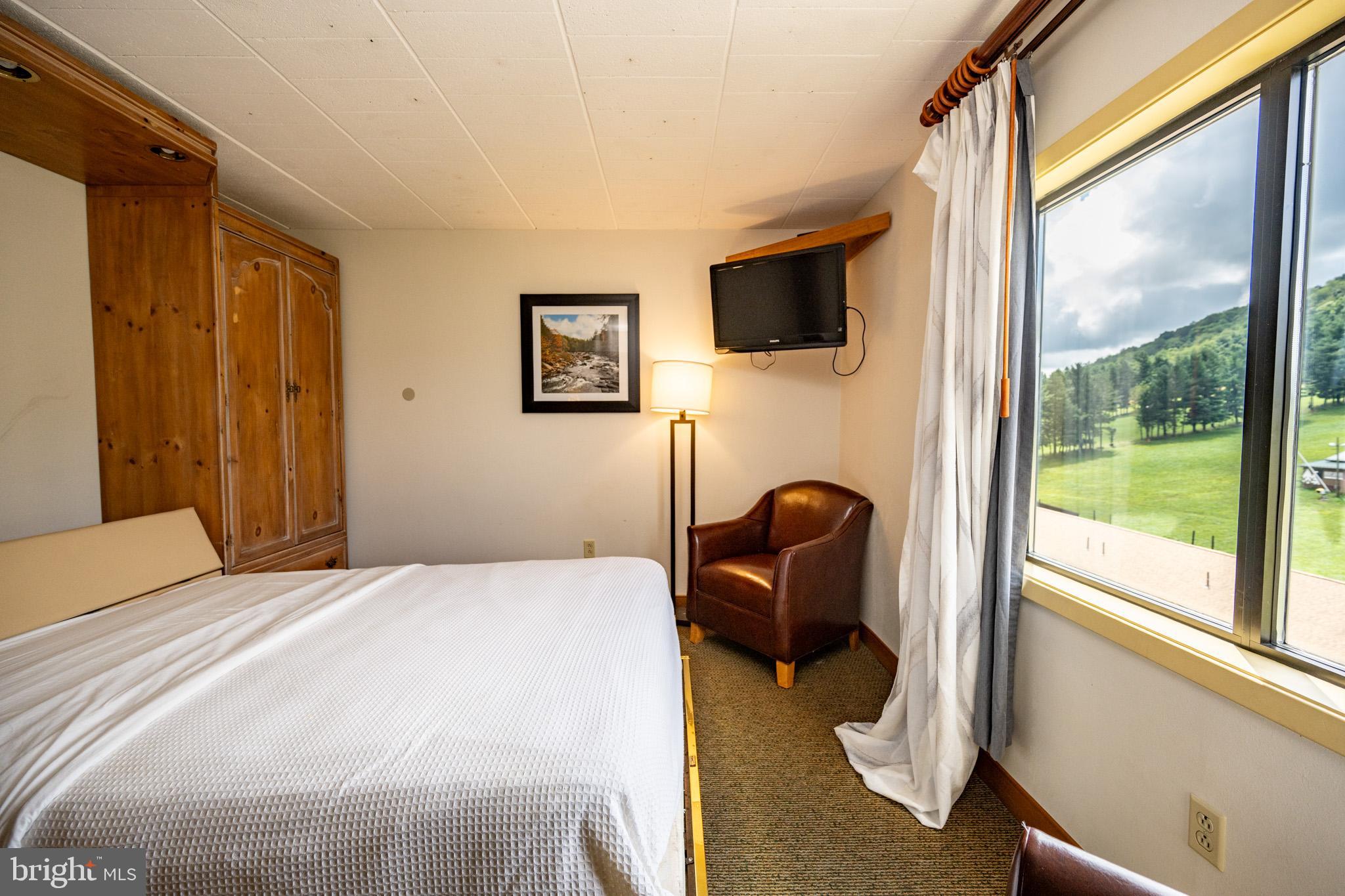 290 Marsh Hill Road, Unit 702K McHenry, MD 21541 - Photo 12 of 45 a bedroom with a bed and a large window