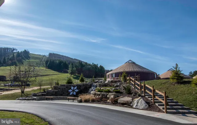 a view of a patio with chairs and a fire pit