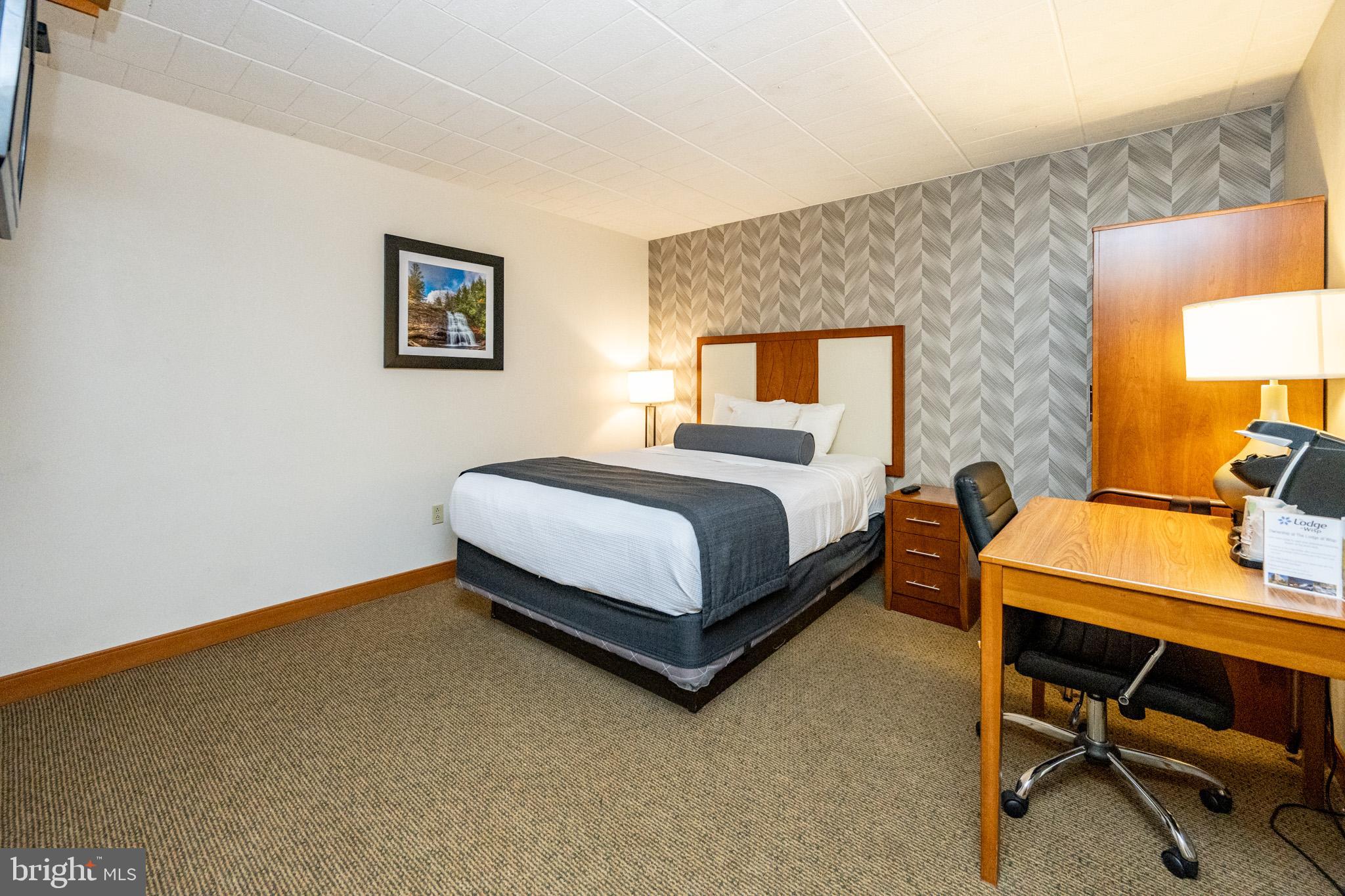 290 Marsh Hill Road, Unit 702K McHenry, MD 21541 - Photo 5 of 45 a bedroom with a bed and a table in it