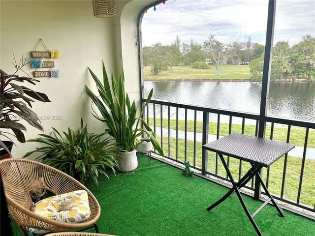 a view of a swimming pool with a yard and sitting area