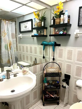 a bathroom with a sink a mirror and a toilet