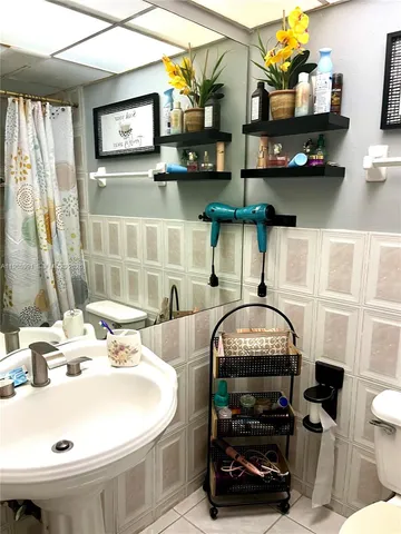 a bathroom with a sink a mirror and a toilet