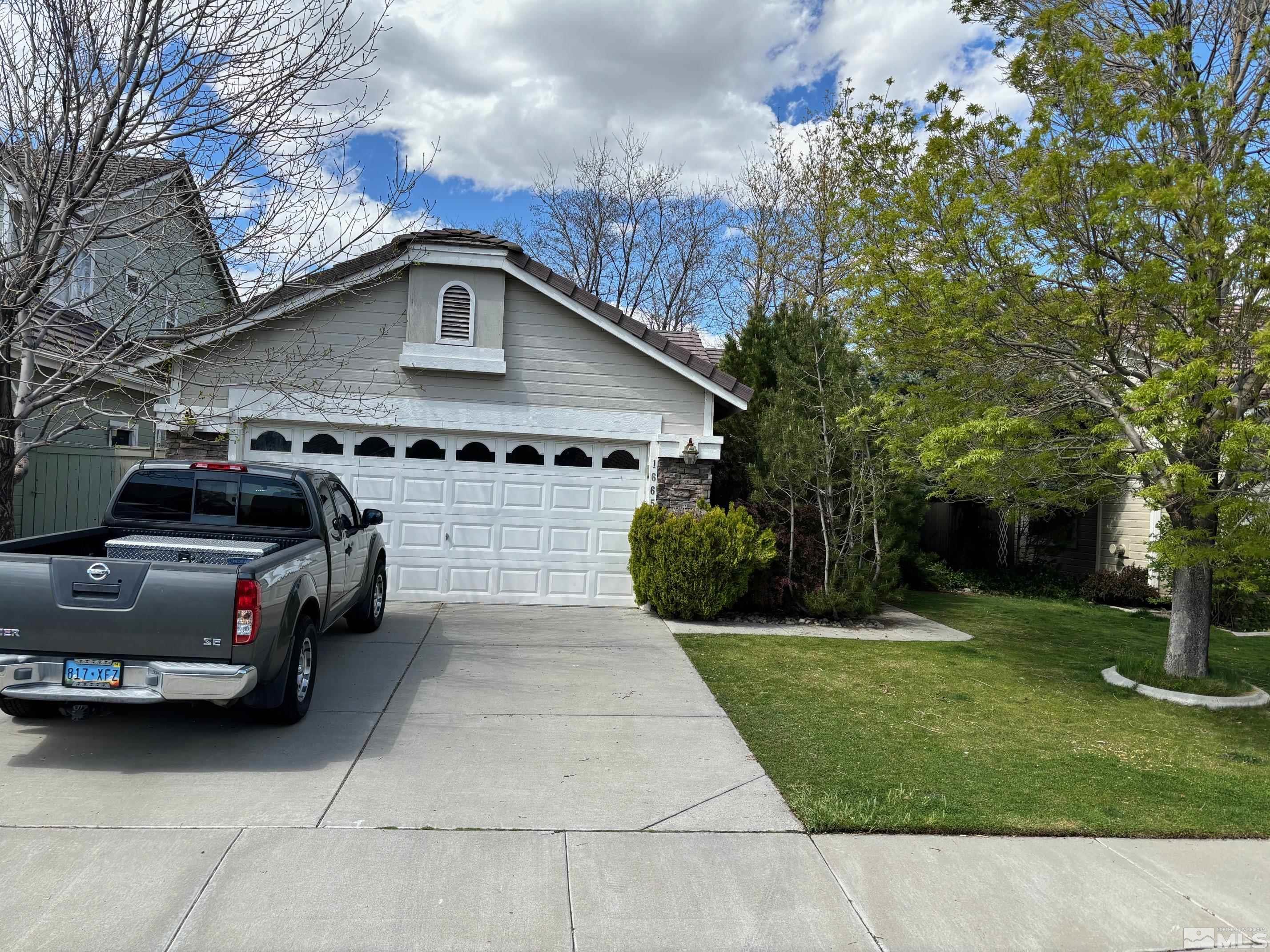 1665 Eastmont Lane Reno, NV 89521 - Photo 1 of 1 a view of a car parked in front of a brick house with plants