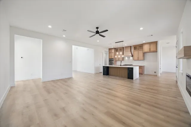 a view of a kitchen with a sink and a refrigerator