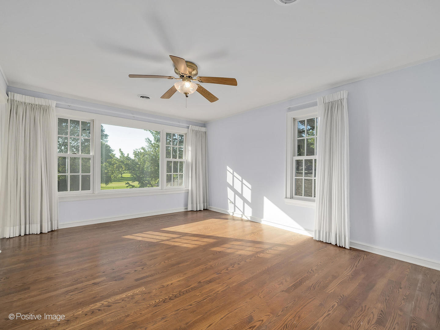 232 Middaugh Road Clarendon Hills, IL 60514 - Photo 11 of 24 a view of empty room with wooden floor and fan