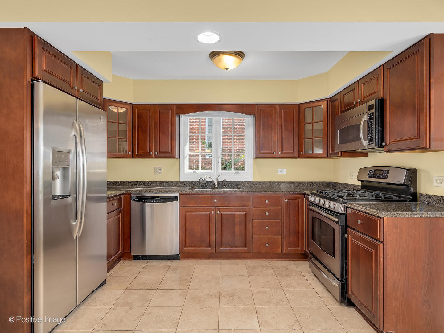 232 Middaugh Road Clarendon Hills, IL 60514 - Photo 2 of 24 a kitchen with stainless steel appliances granite countertop a stove top oven a sink and dishwasher a refrigerator with wooden cabinets