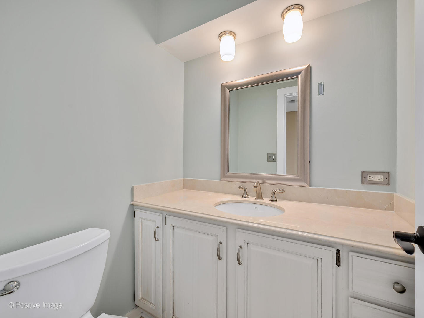 232 Middaugh Road Clarendon Hills, IL 60514 - Photo 10 of 24 a bathroom with a sink a toilet and mirror