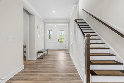 a view of a room with wooden floor and staircase