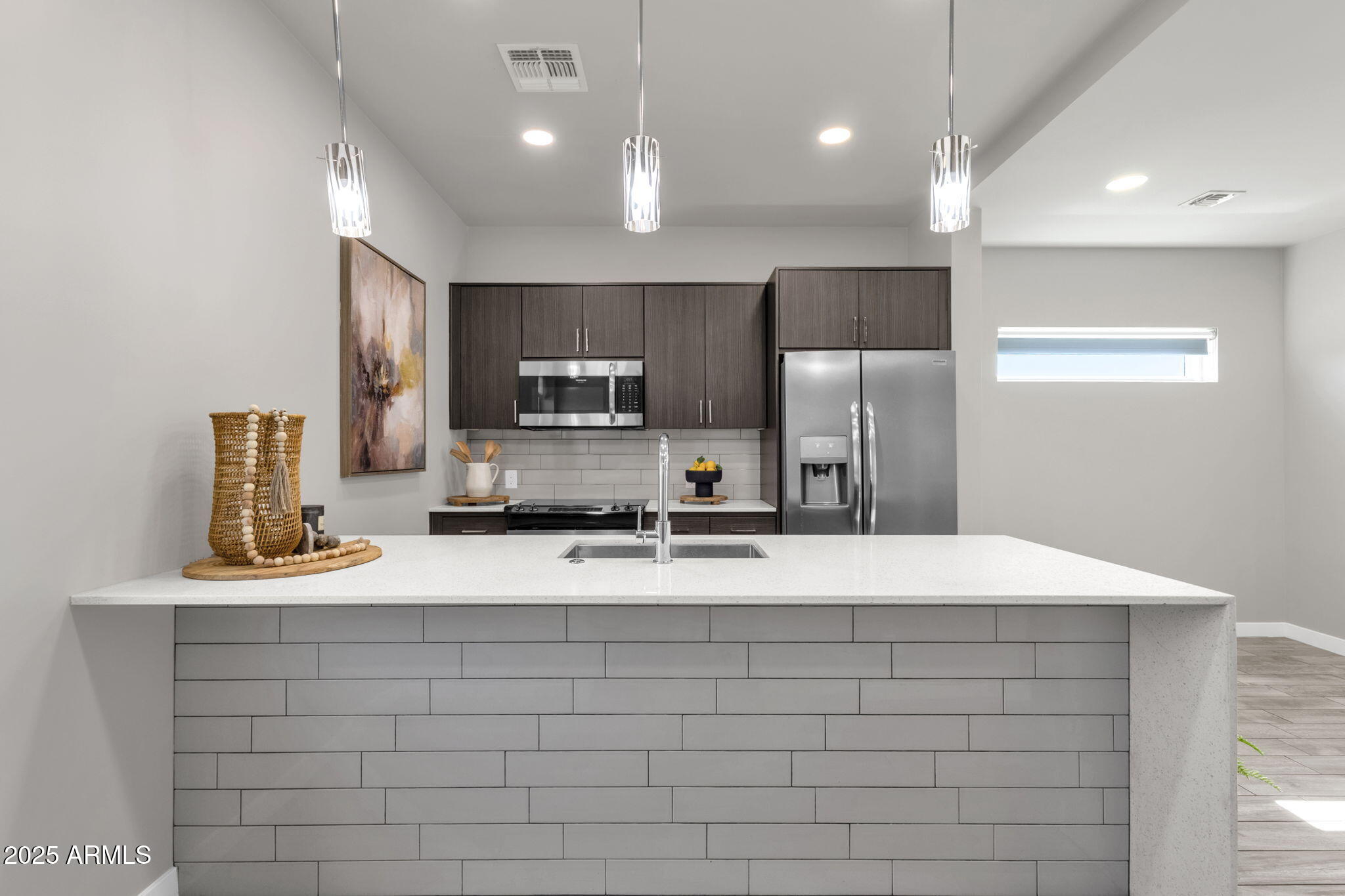 2727 East Thomas Road, Unit 9 Phoenix, AZ 85016 - Photo 11 of 46 a kitchen with kitchen island stainless steel appliances a sink and a refrigerator