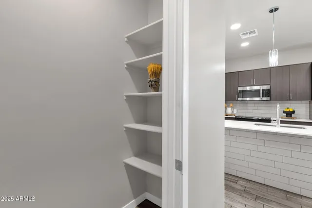 a kitchen with stainless steel appliances a refrigerator and microwave