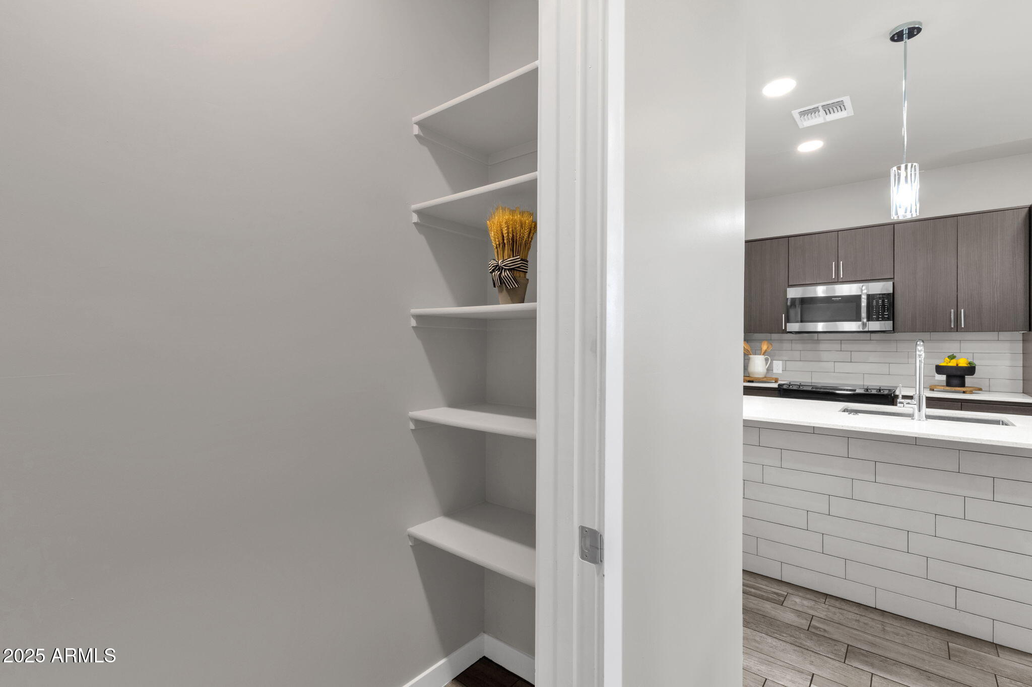 2727 East Thomas Road, Unit 9 Phoenix, AZ 85016 - Photo 12 of 46 a kitchen with stainless steel appliances a refrigerator and microwave