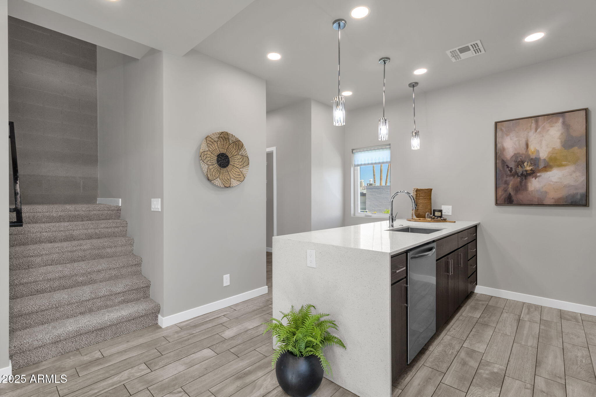2727 East Thomas Road, Unit 9 Phoenix, AZ 85016 - Photo 17 of 46 a kitchen with stainless steel appliances granite countertop a sink a stove and a wooden floors