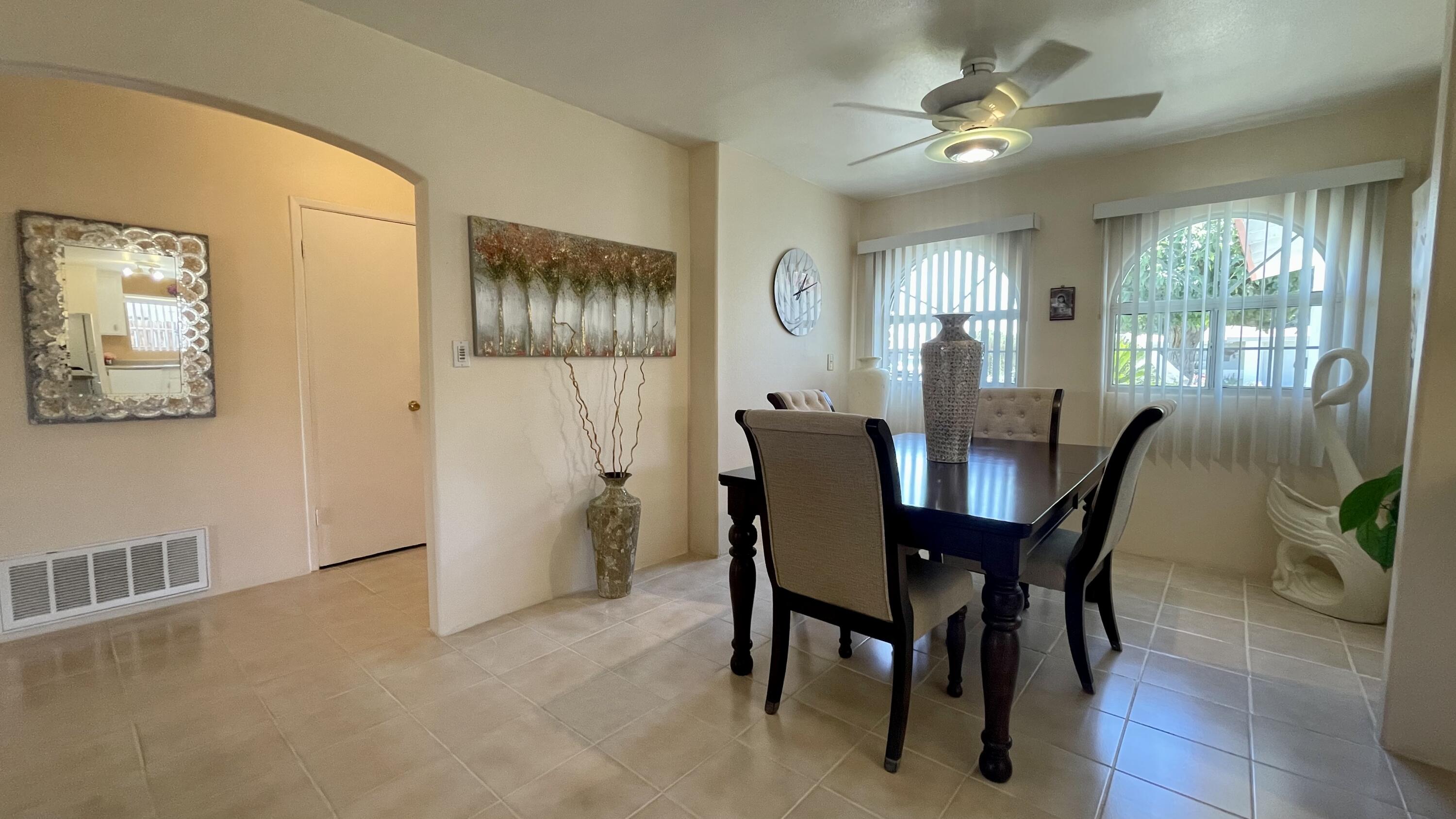 82116 Adobe Road Indio, CA 92201 - Photo 17 of 70 a view of a dining room with furniture window and wooden floor