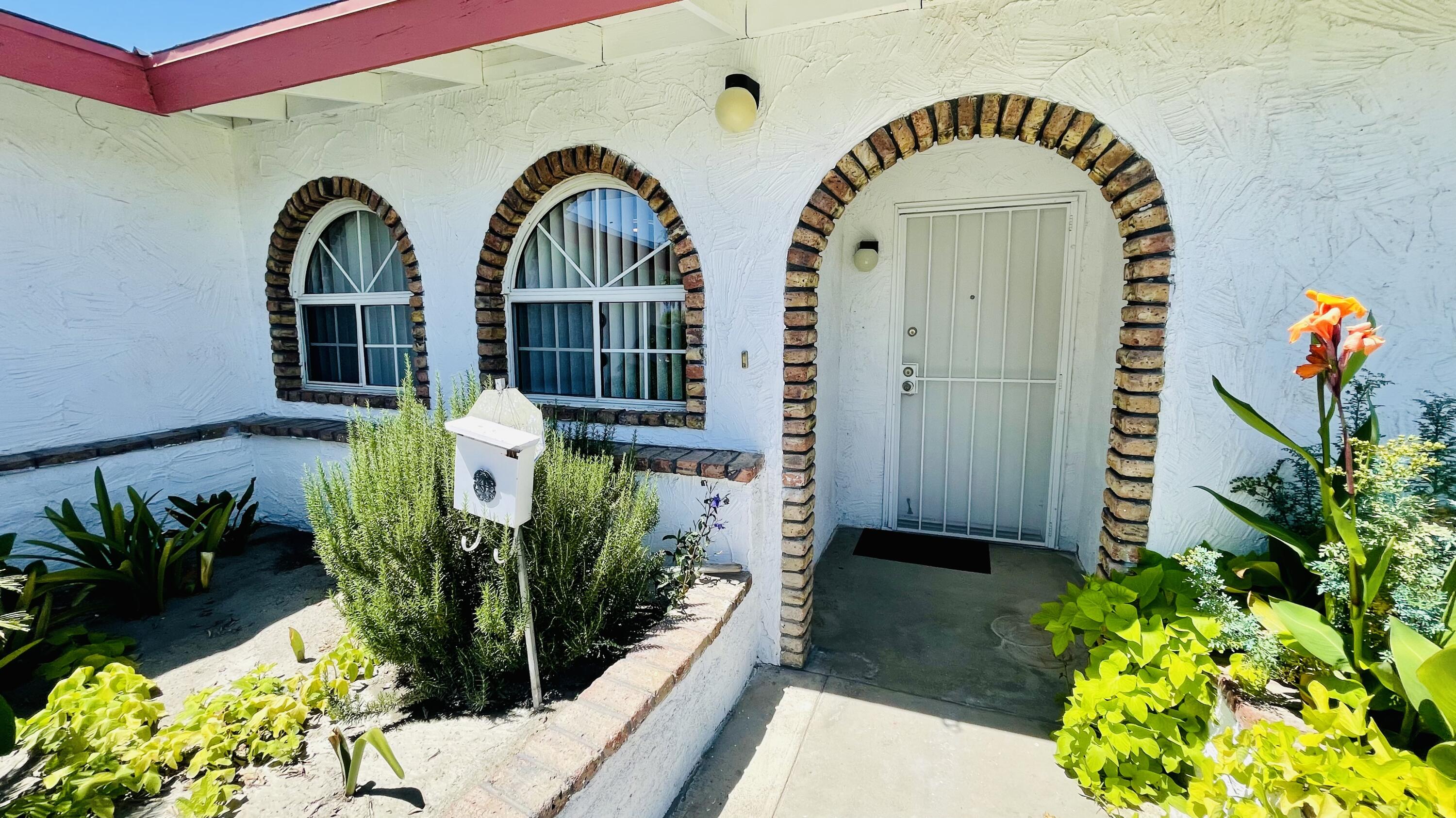 82116 Adobe Road Indio, CA 92201 - Photo 4 of 70 a front view of a house with a garden