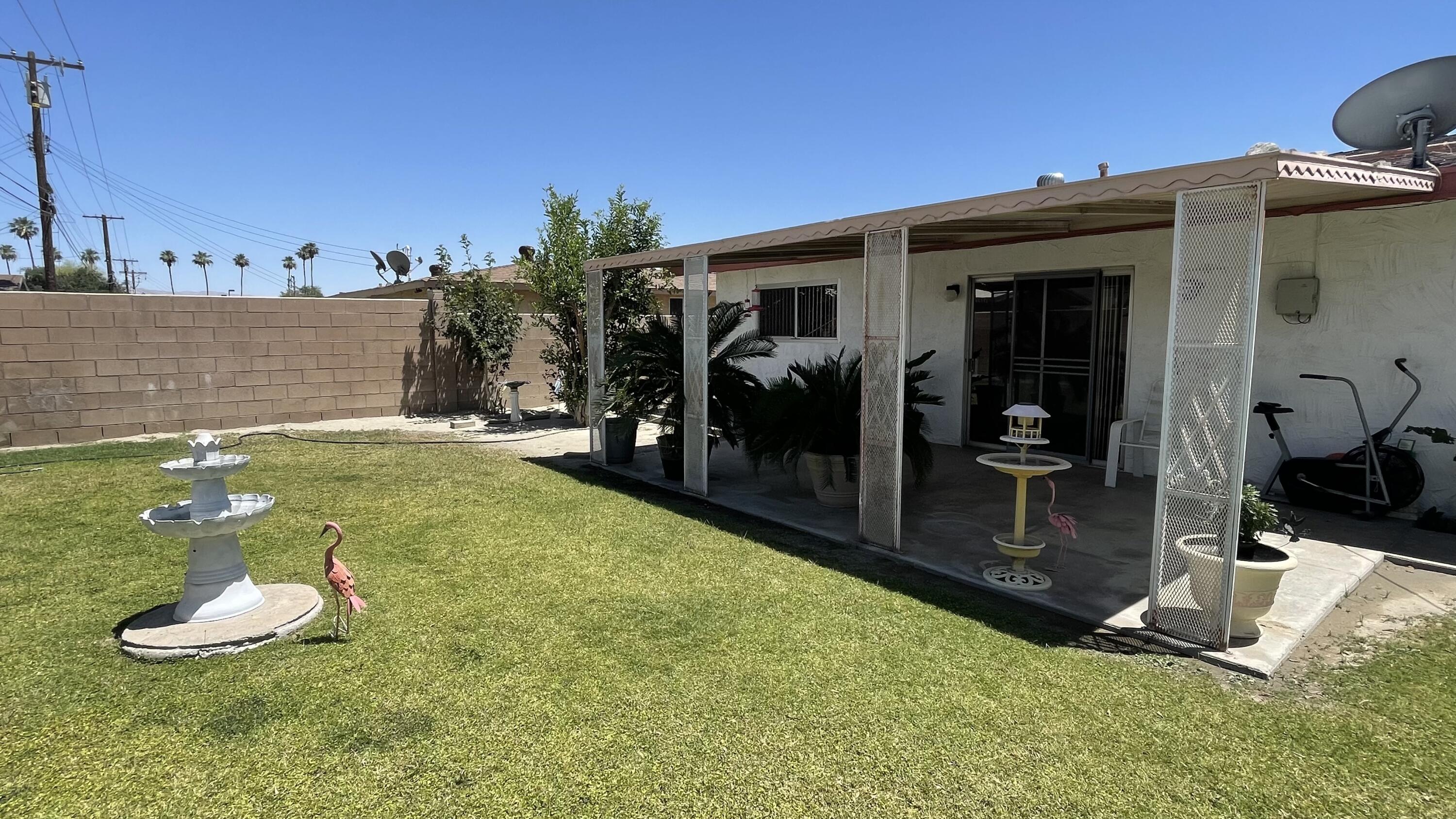 82116 Adobe Road Indio, CA 92201 - Photo 45 of 70 a view of a porch with furniture and a yard
