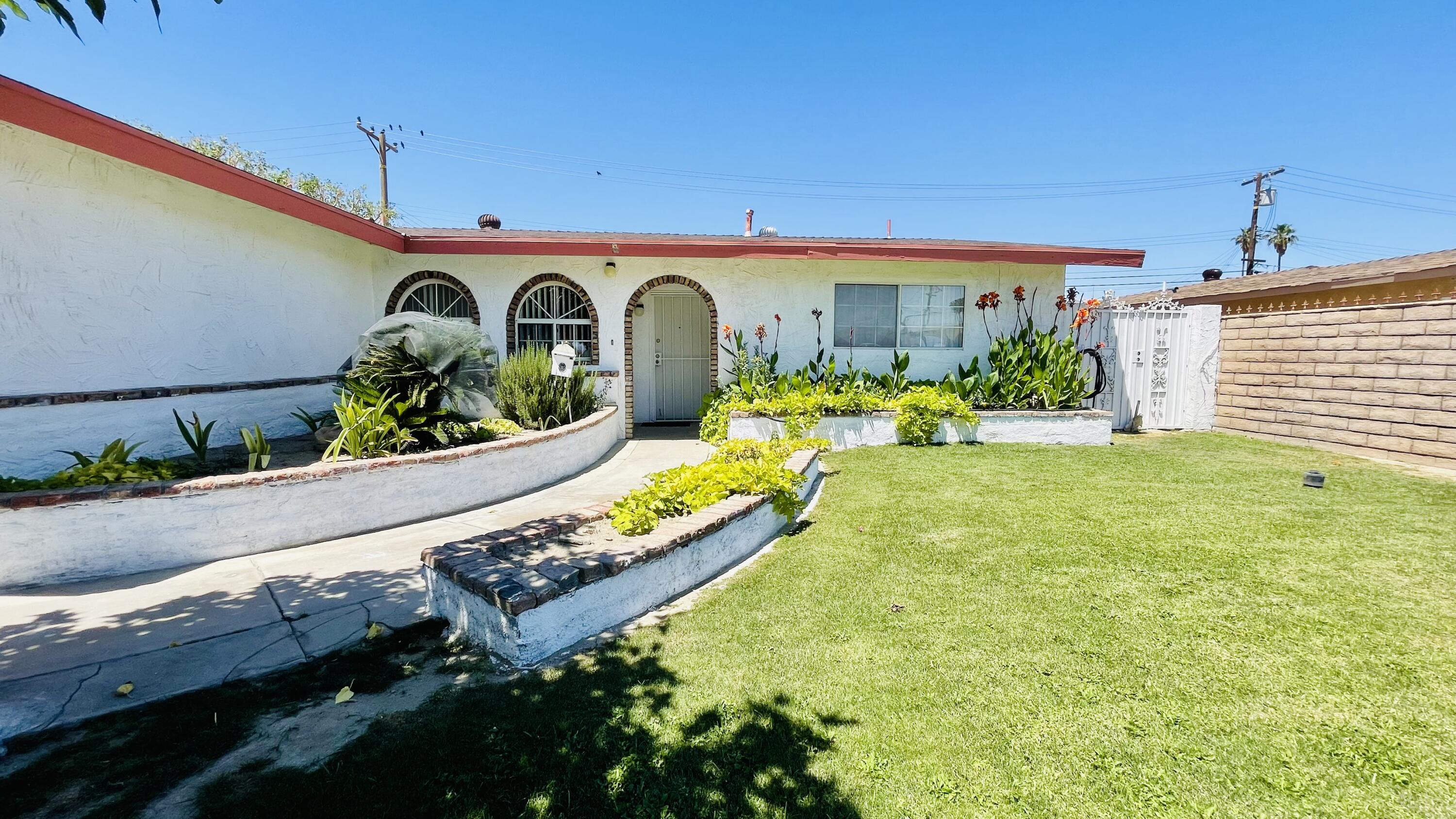 82116 Adobe Road Indio, CA 92201 - Photo 60 of 70 a swimming pool with outdoor seating and yard