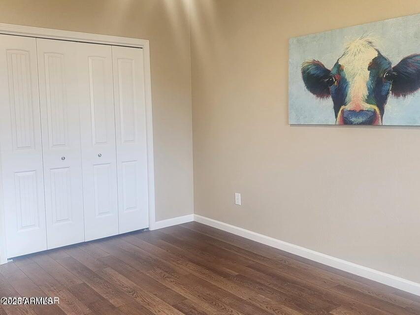 5523 Turkey Run Road Show Low, AZ 85901 - Photo 8 of 13 an empty room with wooden floor and closet