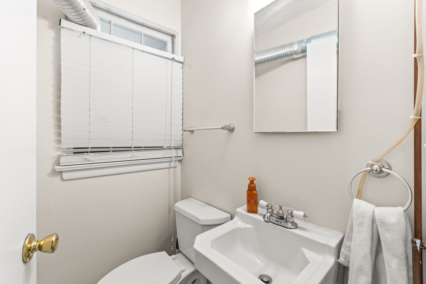 219 East Sheridan Road Lake Bluff, IL 60044 - Photo 14 of 28 a bathroom with a sink a toilet and shower curtain