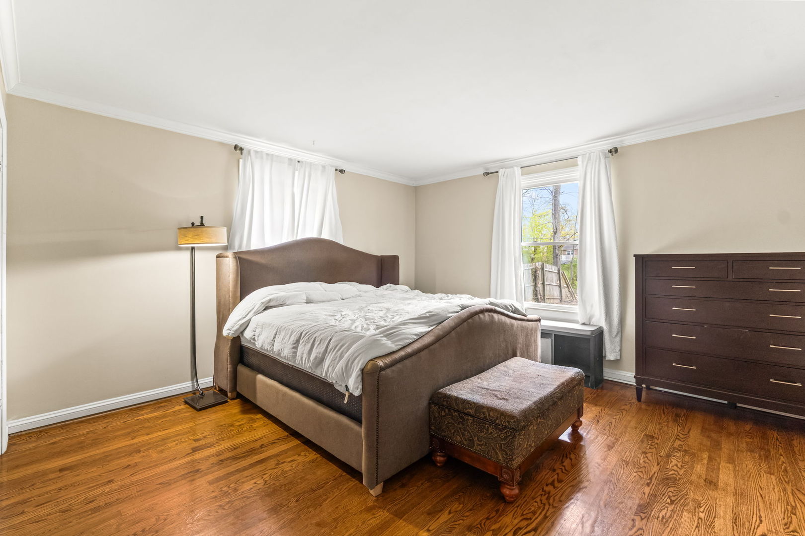 219 East Sheridan Road Lake Bluff, IL 60044 - Photo 19 of 28 a spacious bedroom with a bed and a dresser