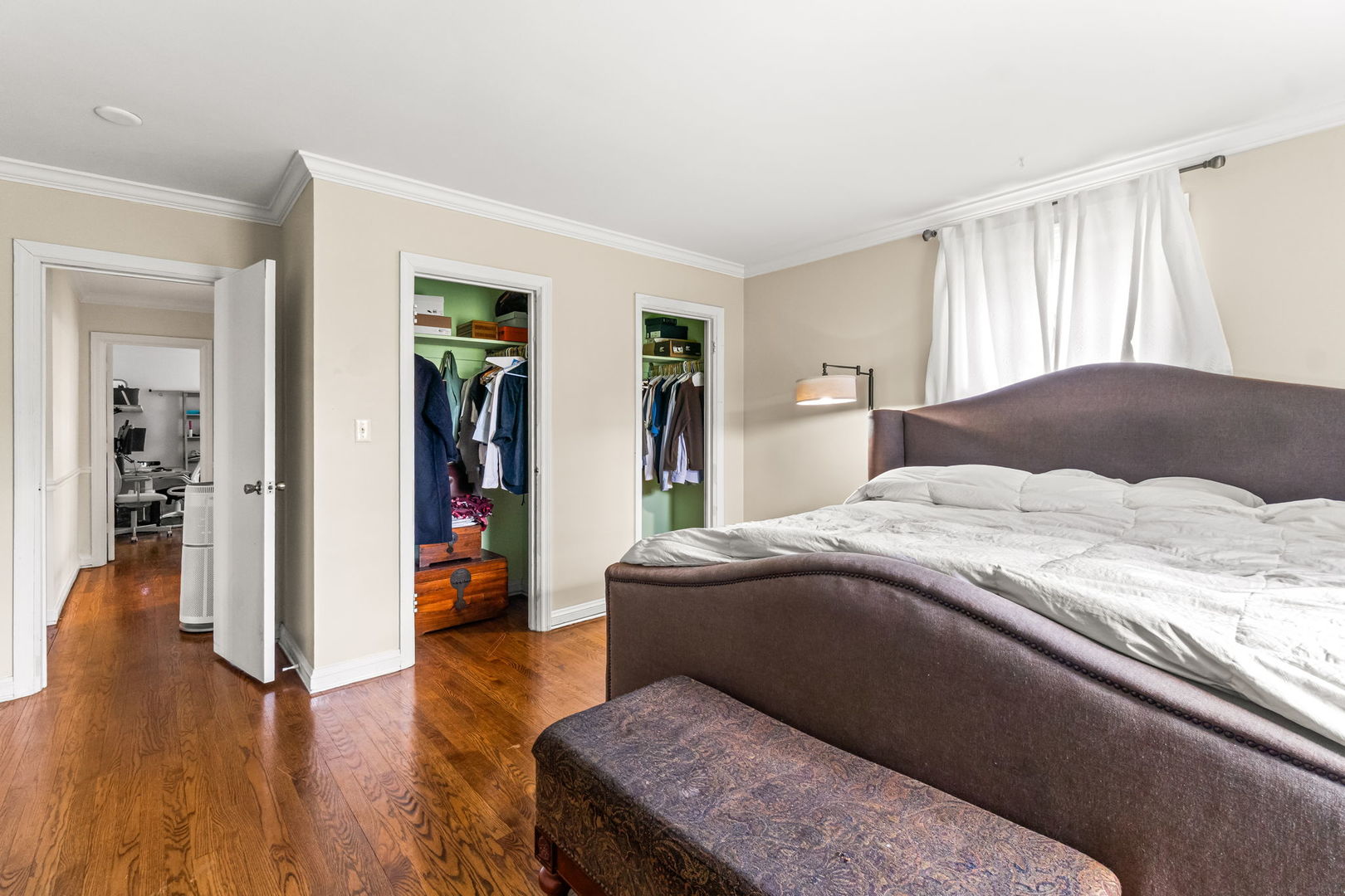 219 East Sheridan Road Lake Bluff, IL 60044 - Photo 20 of 28 a bedroom with a large bed and a wooden floor
