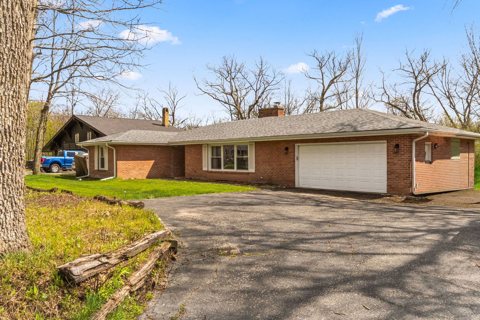 219 East Sheridan Road Lake Bluff, IL 60044 - Photo 2 of 28 a front view of a house with a yard and garage