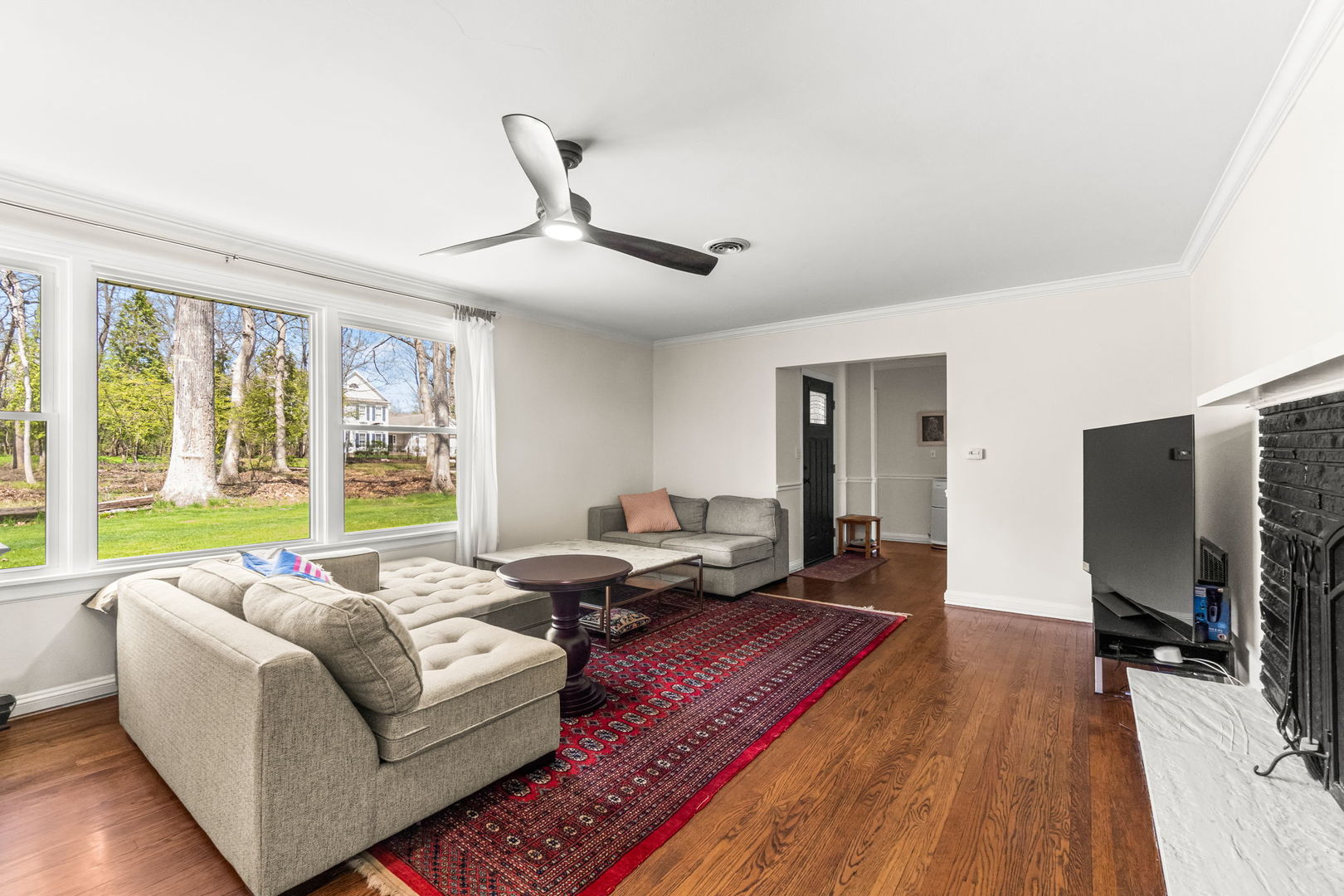 219 East Sheridan Road Lake Bluff, IL 60044 - Photo 7 of 28 a living room with furniture flat screen tv and a large window
