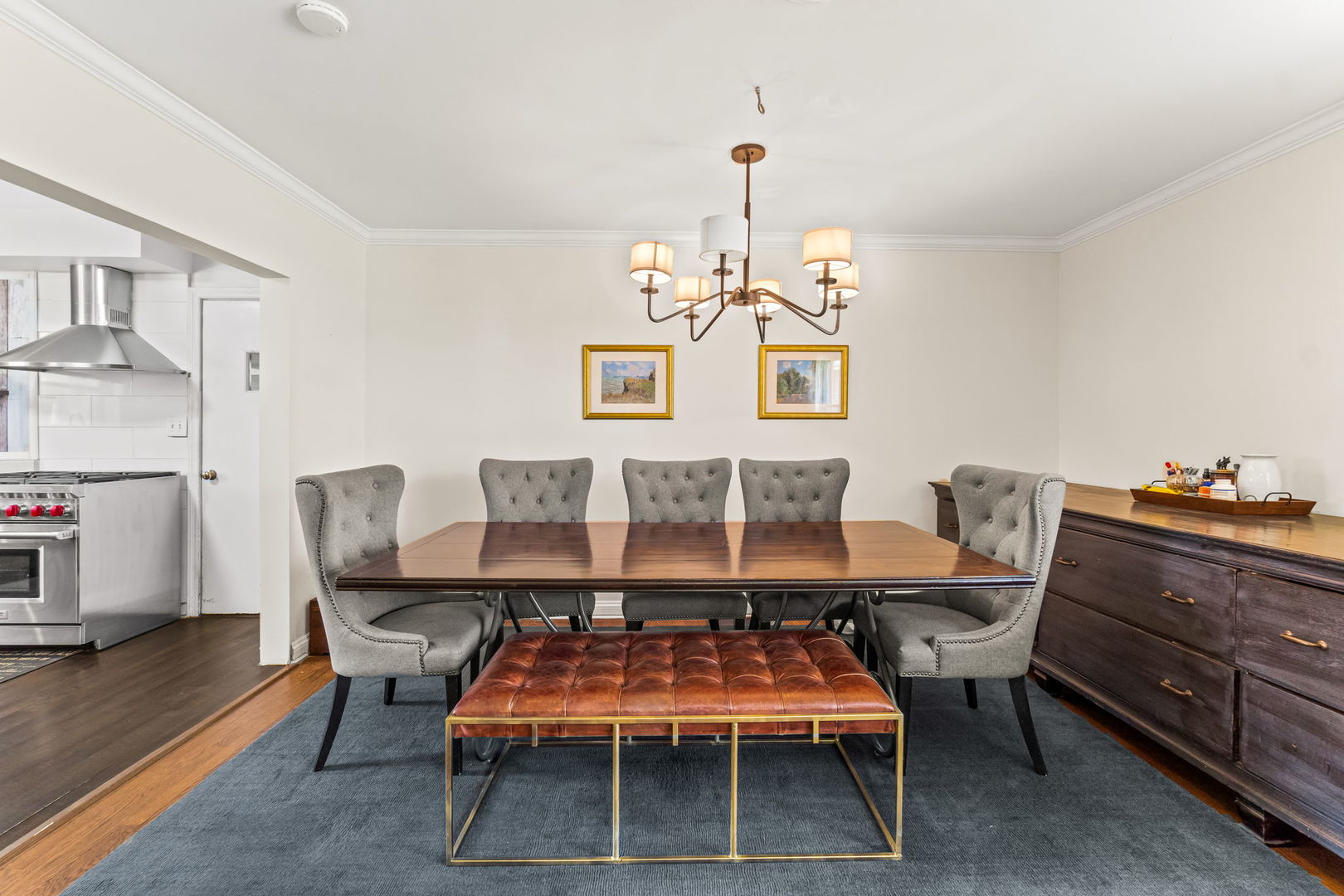 219 East Sheridan Road Lake Bluff, IL 60044 - Photo 8 of 28 a dining room with wooden floor a chandelier a wooden table and chairs
