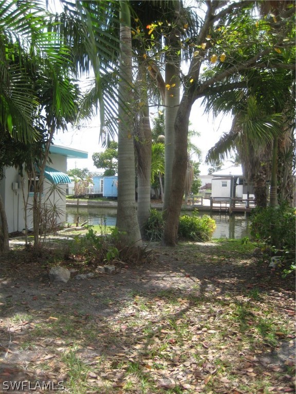 2567 Cay Cove Matlacha, FL 33993 - Photo 13 of 18 a backyard of a house with lots of green space