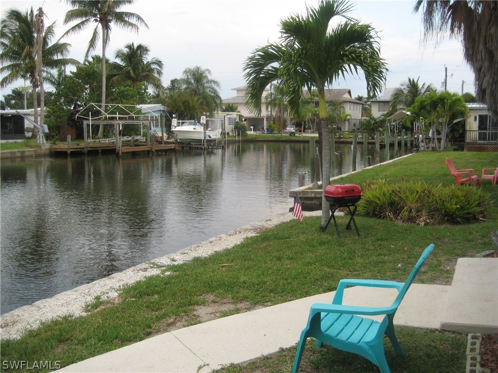 2567 Cay Cove Matlacha, FL 33993 - Photo 14 of 18 a view of a lake with a table and a chairs