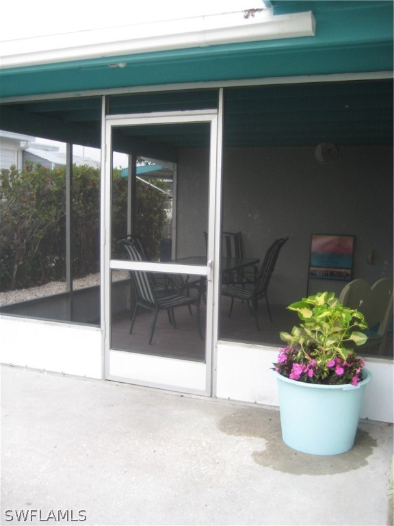 2567 Cay Cove Matlacha, FL 33993 - Photo 15 of 18 a view of a glass door with a potted plant