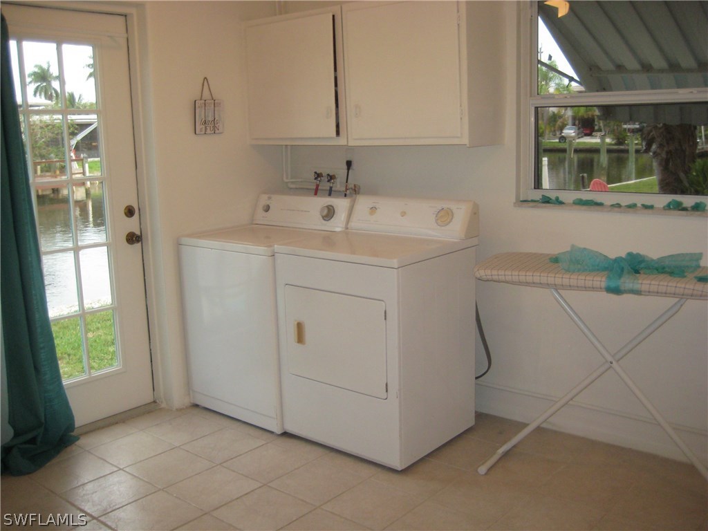 2567 Cay Cove Matlacha, FL 33993 - Photo 17 of 18 a utility room with a sink dryer and washer