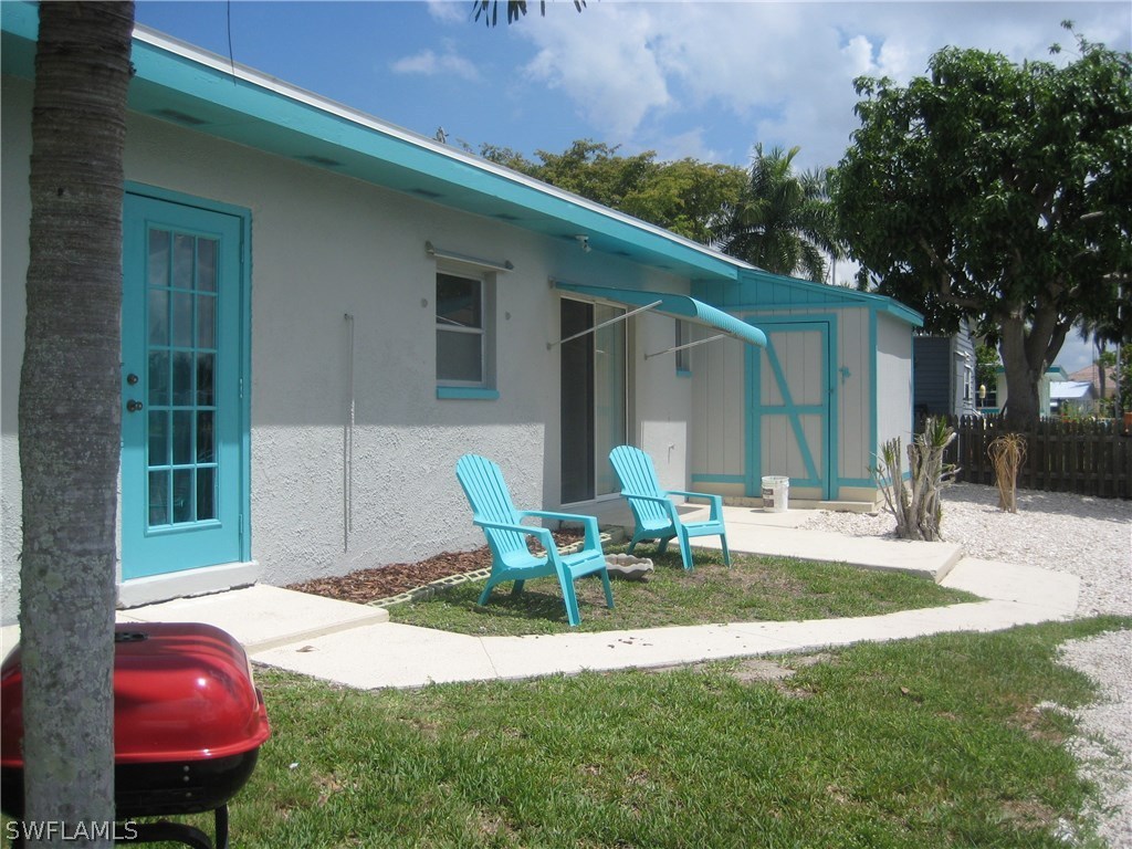 2567 Cay Cove Matlacha, FL 33993 - Photo 18 of 18 a backyard of a house with table and chairs